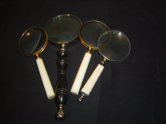 4 lg. magnifying glasses: One With Wood Handle, Others have Plastic Handles