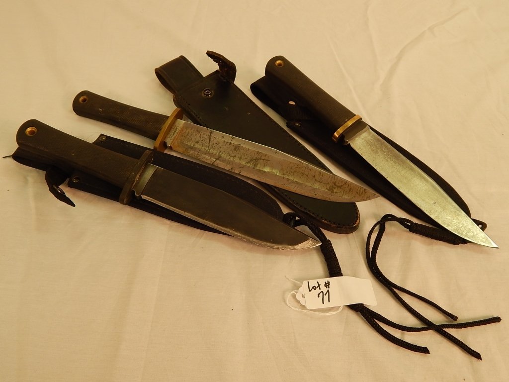 Collection of knives and sheath: comprised of a trail master cold steel, two steel knives with rubber handles.