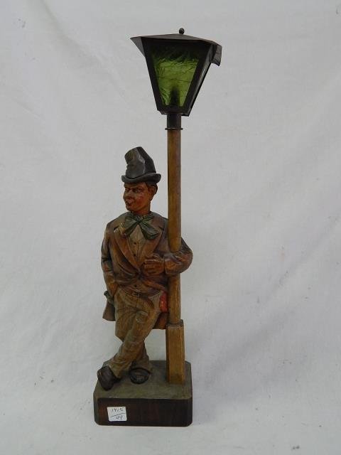 WOOD CARVED WHISTLER GREEN GLASS: ONE GREEN GLASS PANE CRACKED, BELLOWS DRY, NO KEY. 19" TALL. NO BOTTOM DOOR.