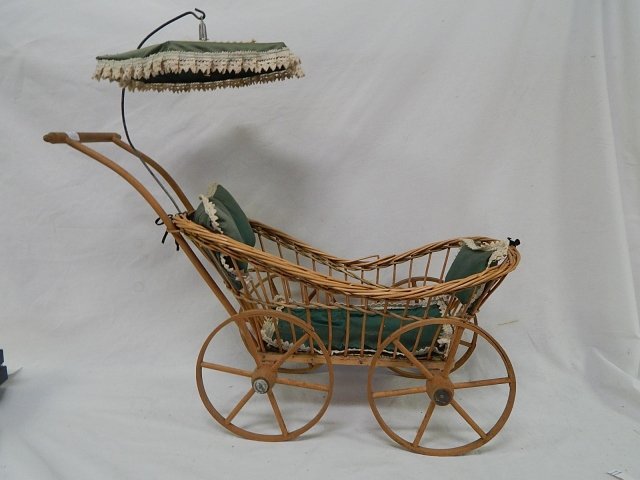 DOLL SIZE WICKER BABY BUGGY: 24" TALL AND 26 WIDE. CONDITION IS GOOD. WOODEN WHEELS