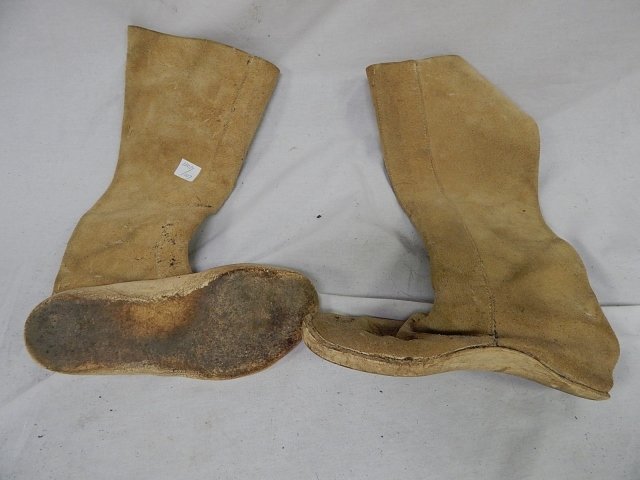 PAIR OF LEATHER MOCCASIN BOOTS: LADIES MOCCASINS. A LITTLE ROUGH AROUND THE EDGES. SOLES ARE 9 1/2".
