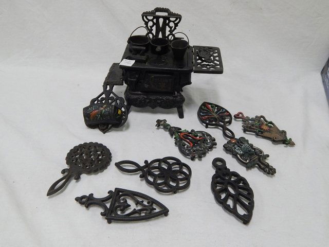 DOLL STOVE AND TRIVETS: STOVE IS 8" TALL X 9 1/2" WIDE. TRIVETS AVERAGE 5".
