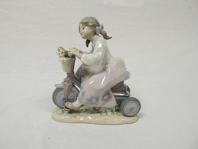 LLADRO GIRL ON A BIKE WITH PUPPIES: 6 3/4" TALL. NO BOX. CONDITION IS GOOD.