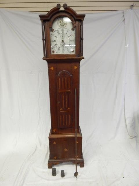 PENNSYLVANIA GRANDFATHER CLOCK: PENNSYLVANIA GERMAN INLAID GRANDFATHERS CLOCK. WALNUT WOOD, WITH MIXED WOOD INLAY. WOODEN WORKS. WORKS COMPLETE WITH PENDULUM. SOLD AS IS. 84" TALL, 20" WIDE, 12 1/2" DEEP.