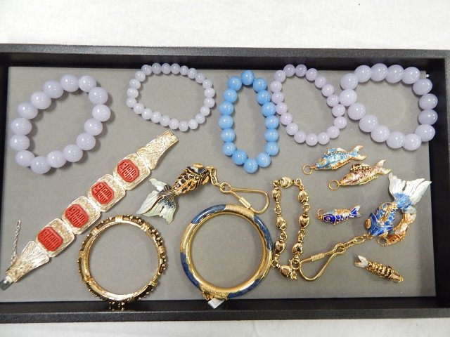 COLLECTION OF COSTUME JEWELRY: GLASS BEADS, BRACELET MARKED SILVER, ENAMEL FISH, AND MORE.