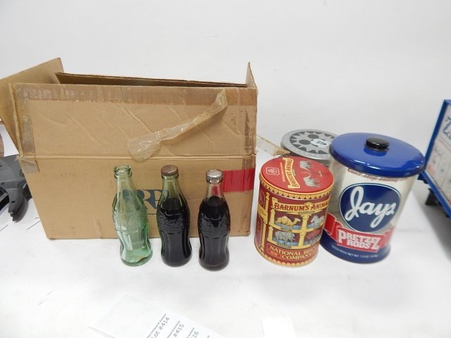 13 COKE BOTTLES, TWO OF THEM FULL: INCLUDES JAYS PRETZELS AND TIN. CONDITION AS SHOWN.