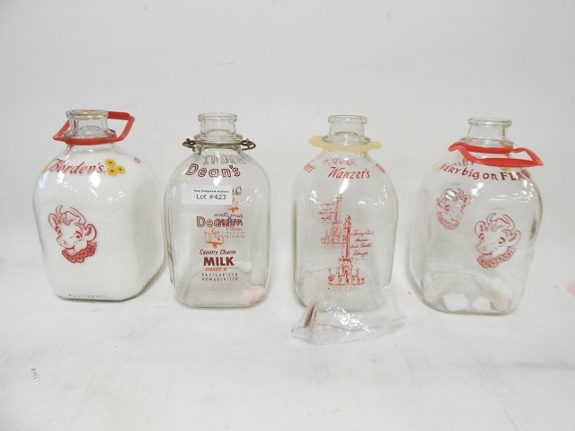 FOUR GALLON GLASS MILK BOTTLES: CONDITION AS SHOWN. BORDEN, DEANS AND MORE!