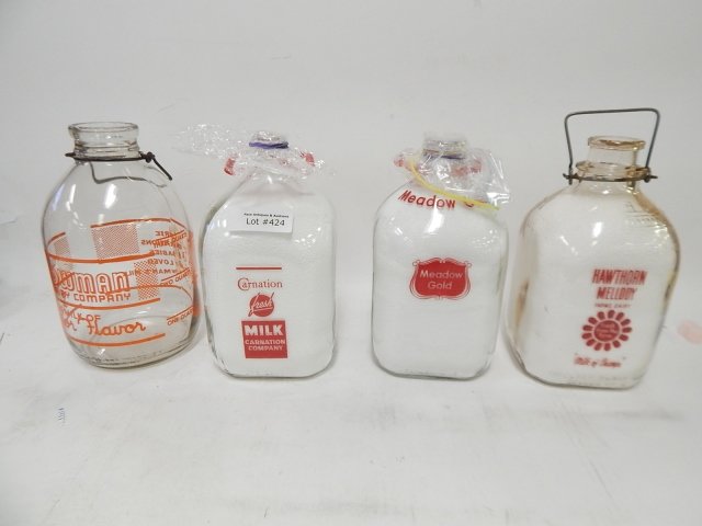 FOUR GLASS GALLON MILK BOTTLES: CONDITION AS SHOWN. BORDENS, HAWTHORN, AND MORE.