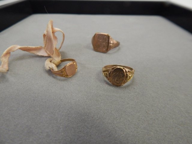 THREE 10K GOLD INITIAL RINGS: TWO BABY RINGS AND ONE LADIES RING.