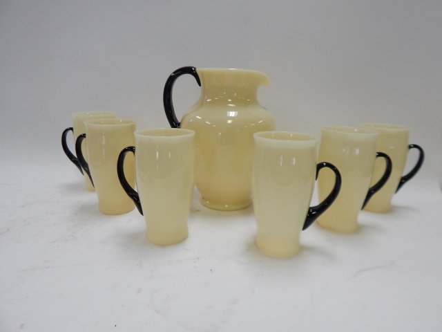 HAND BLOWN CUSTARD GLASS WATER SET: PITCHER AND SIX GLASSES. POSSIBLY STUBEN. PITCHERS IS 9 1/2" TALL. GLASSES ARE 6 1/2" TALL. NEEDS CLEANING. GOOD CONDITION. Handles are fine