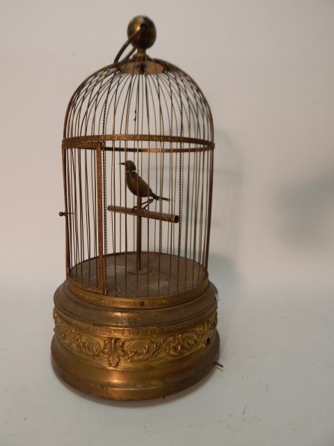 BRASS BIRD CAGE WITH SINGING BIRD: 21" TALL. BIRD IS BALD, LOST HIS FEATHERS. NO KEY. SOLD AS IS. MADE IN FRANCE.