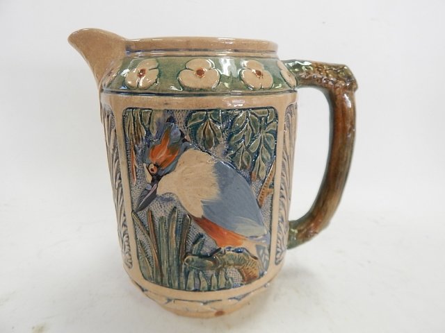 POTTERY PITCHER: ADVERTISING ON BOTTOM. 8" TALL. SMALL CHIP ON THE BOTTOM.