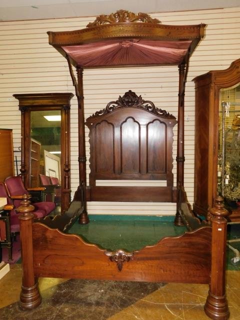 HALF TESTER BED: DARK WOOD FINISH. FABRIC TORN/STAINED. MISSING FINIALS AND SMALL TRIM PIECES. 106" TALL, 62" WIDE
