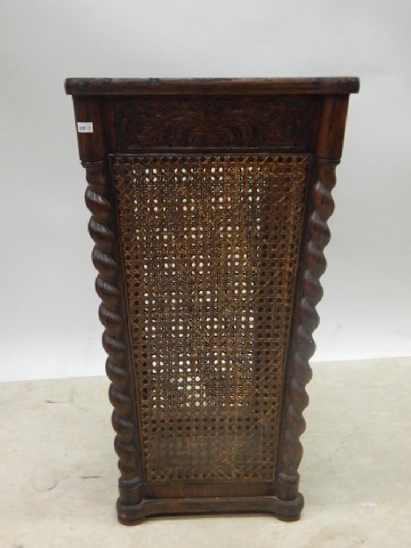 OAK UMBRELLA STAND: 28" TALL BARLEY TWIST OAK STAND WITH CANED SIDES, CANING HAS A HOLE ON ONE SIDE.