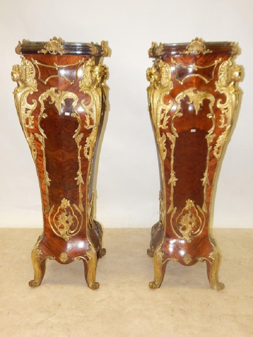 PAIR OF FRENCH BRONZE MOUNTED PEDISTALS: 54" TALL. MARBLE TOPS. FRENCH BRONZE MOUNTS, FULL BUSTED WOMAN. SATIN AND ROSEWOOD VENEER. BOMBAY AND SERPENTINE ON ALL SIDES. OVERALL GOOD CONDITION