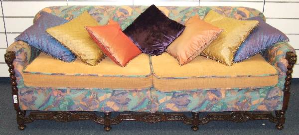 ANTIQUE CARVED AMERICAN SOFA32"T 87"L 35"D: ANTIQUE CARVED AMERICAN SOFA. FEATURING NEW UPHOLSTERY AND SATIN BEADED PILLOWS. REFINISHED WALNUT FRAME WITH CARVED LION HEAD ARMS SUPPORTED BY ROPE TWIST COLUMN AND PIERCED CARVED STRETCHERED BOTTOM