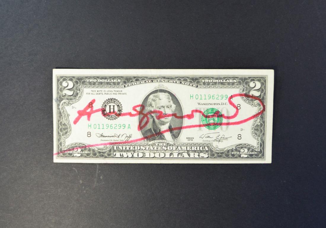 A TWO DOLLAR US BILL BEARING SIGNATURE ANDY WARHOL: A TWO DOLLAR US BILL BEARING SIGNATURE ANDY WARHOL. SGD IN RED MARKER, CIRCA 1970'S. EXCELLENT CONDITION.