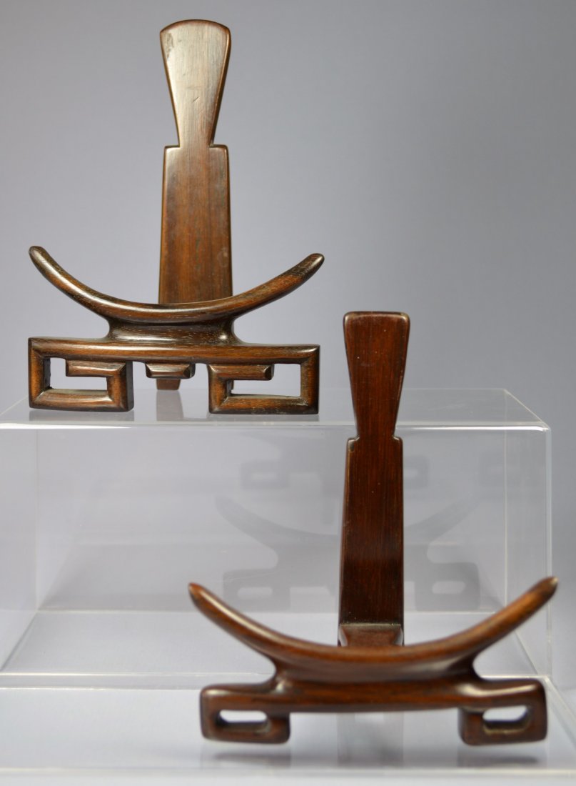 CHINESE PAIR OF CARVED ANTIQUE PLATE STANDS 19TH C: A pair of Chinese carved rosewood charger stands, heights 5 and 6 inches respectively, from ca. 19th c. Probably suitable for chargers between 10 and 12 inches in diameter. Provenance: Private collect