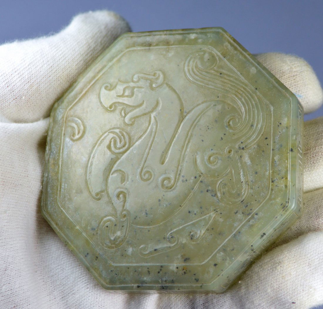 CHINESE QING CARVED OCTAGONAL JADE TRINKET BOX: A superbly carved natural jade lidded dragon trinket box. 80 mm x 30 mm. Exellent condition. Probably 19th c. Provenance: Private collection, Chicago.