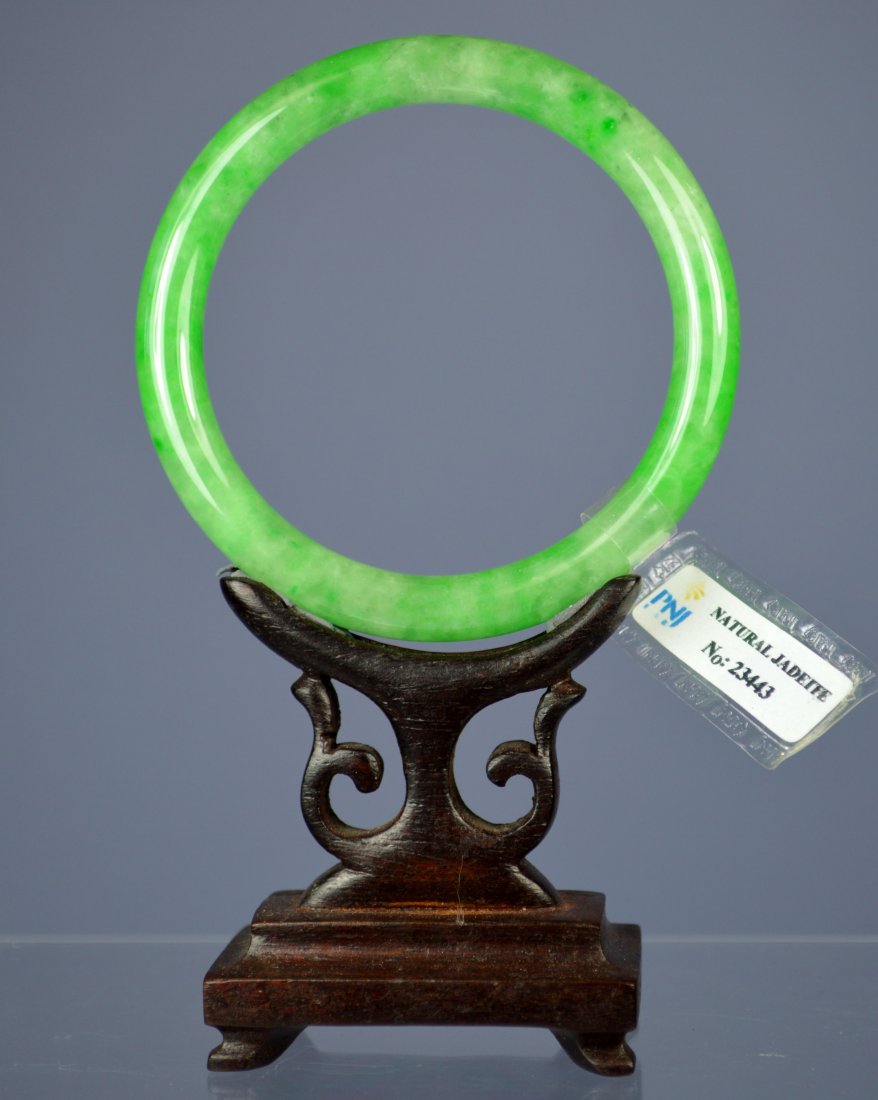 CHINESE CERTIFIED GR. A BANGLE BRACELET: Amazing Chinese grade A apple green certified jade bangle bracelet. 8 mm x 55 mm inside opening. 33 gr. Superb color, polish and translucency. Excellent condition. Provenance: Private collection, Sout