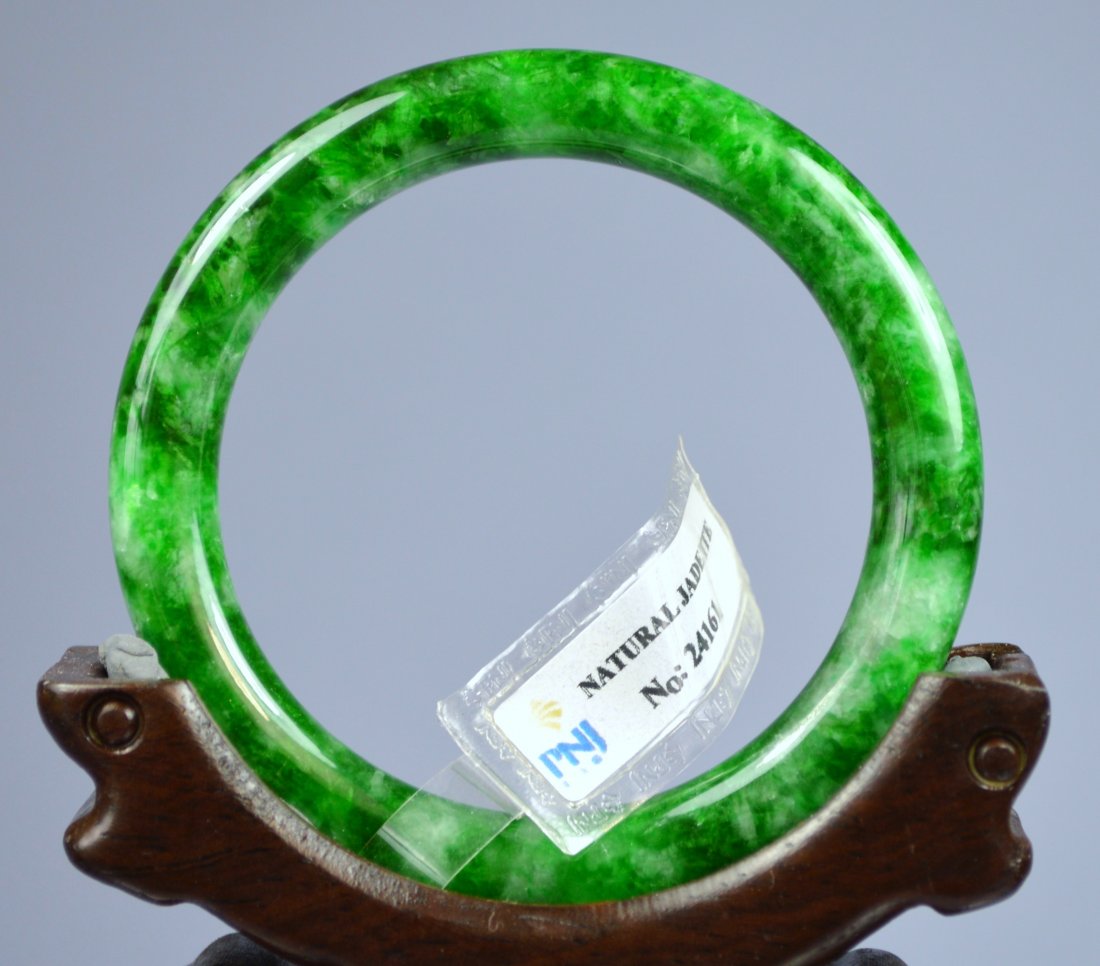 CHINESE TOP CERTIFIED GRADE A GREEN JADE BANGLE: Amazing rare Chinese grade A apple green certified jade bangle bracelet. The piece features a dazzling array of bright green colors. Cabochon 8 mm width x 54 mm inside opening. 149 carats. Superb poli