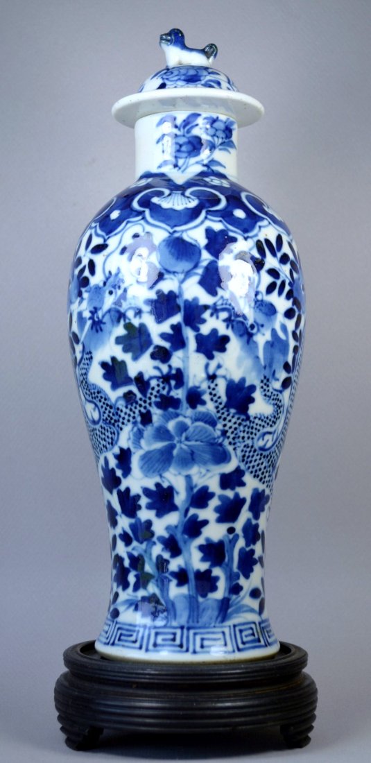 CHINESE KANGXI LIDDED BALUSTER PORCELAIN VASE 18TH C: A beautiful Chinese blue on white porcelain baluster shaped vase with underglaze paint, decorated with dragons, ruyi and tendrils, and witha foo dog decorated lid, 10.5 inches tall. One faint minor ha