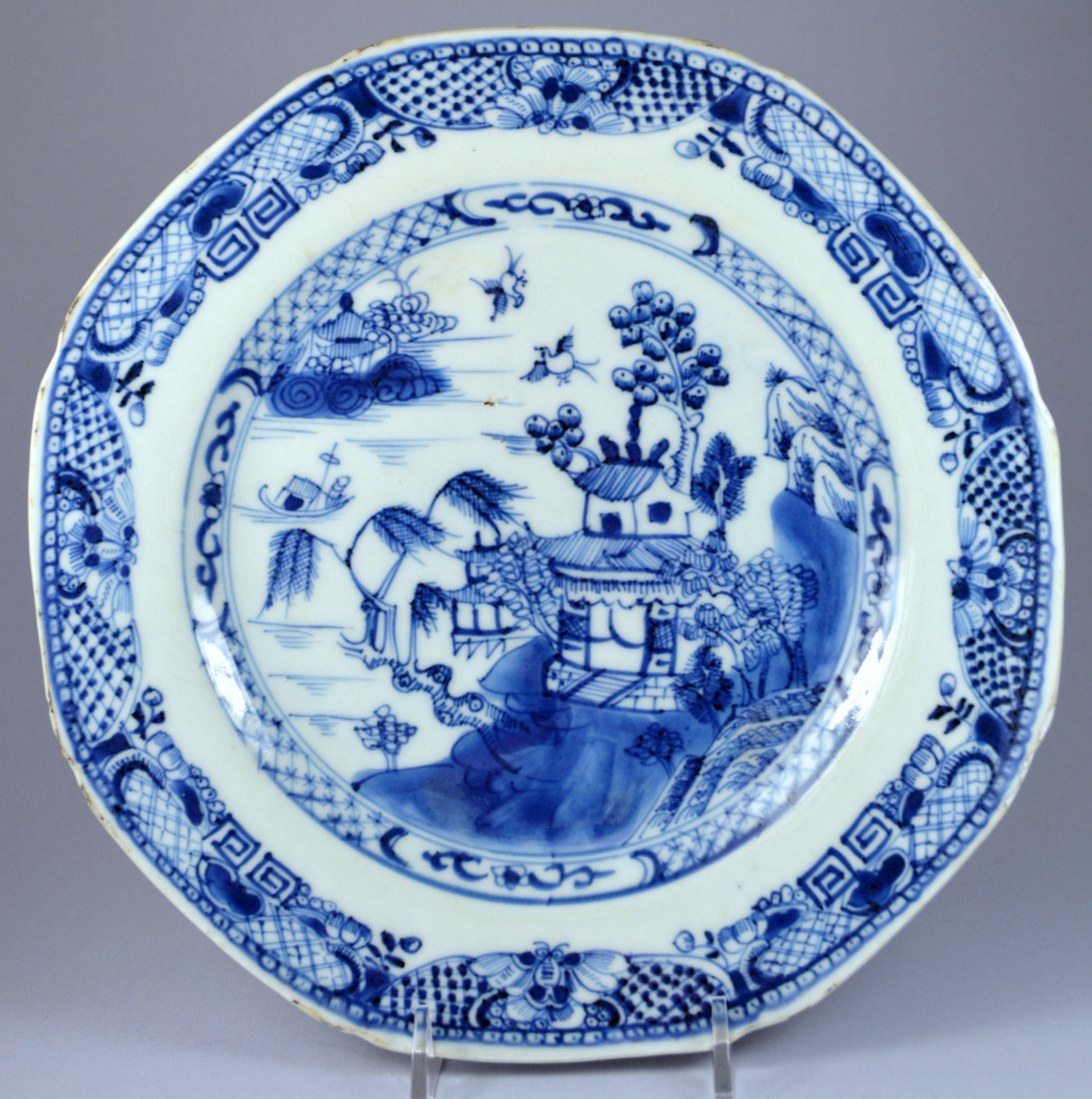 CHINESE QIANLONG OCTAGONAL LANDSCAPE PLATE CA 18TH C: A stunning Chinese Qianlong octagonal blue on white underglaze porcelain plate ca. 1770's. Decorated with figures in landscapes. Size 23 cm. Excellent condition, small frits, one or two minor touch up