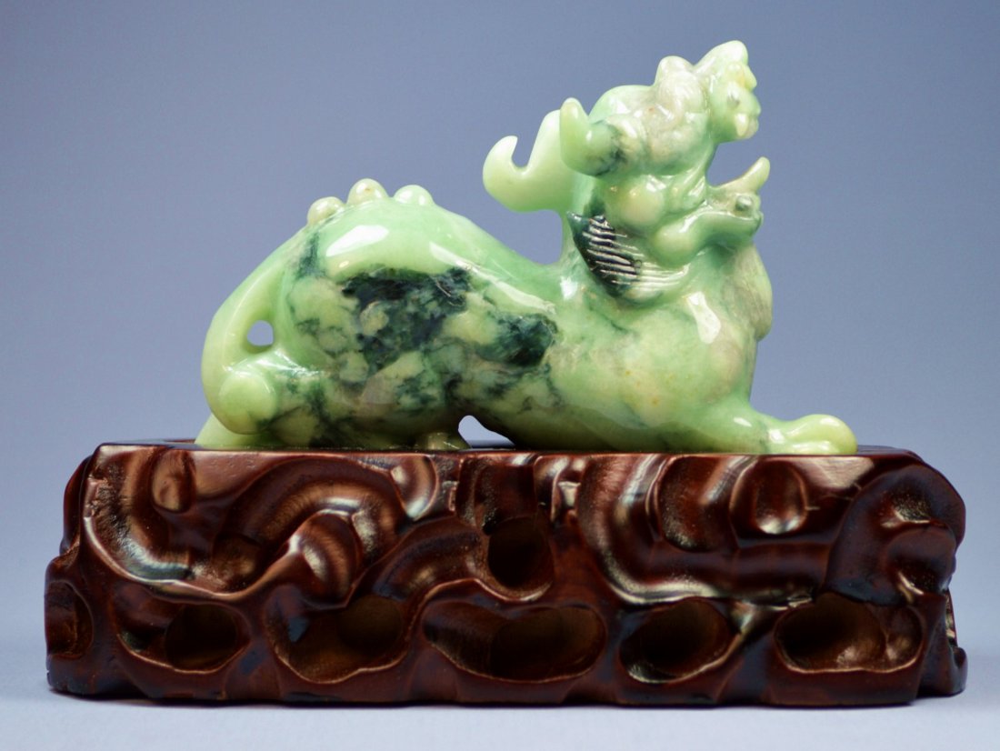 CHINESE NATURAL JADE CARVED QILIN BEAST: A stunning large Chinese Kilin Beast carving of Grade A jade lighter color with mottled darker shades. Size 120 x 70 x 35 mm, a very smooth carving, excellent condition. Provenance: Private collection