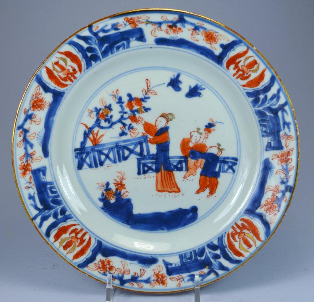 CHINESE KANGXI GILT PORC FIGURAL PLATE CA 17-18TH C: A stunning Chinese figural blue and iron red on white underglaze Kangxi porcelain plate ca 17th C. Depicting a romantic courtyard scene with lady and the young boys, and gilt overglaze, it is a stunni