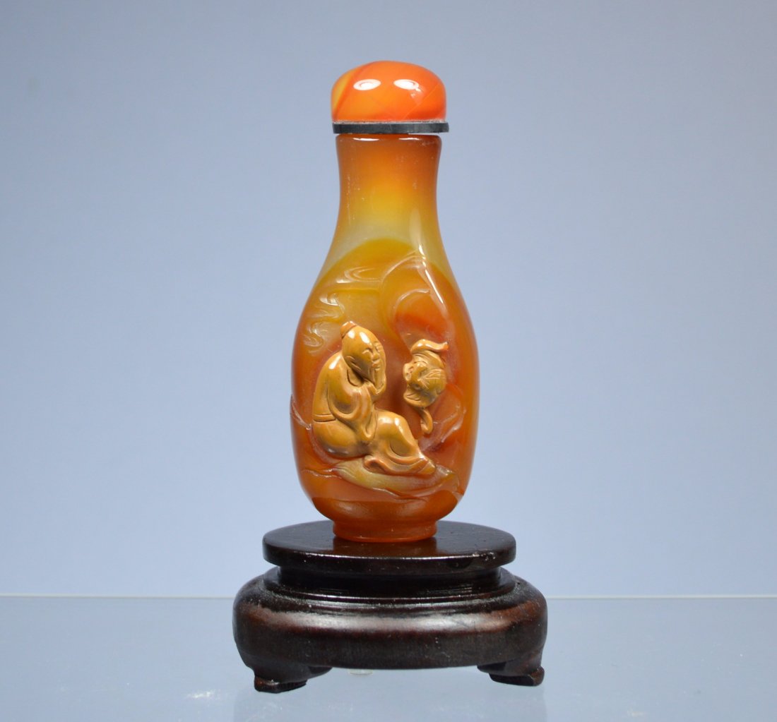 CHINESE CARVED SHADOW AGATE SNUFF BOTTLE: Amazing antique Chinese carved shadow agate snuff bottle with bone spoon. Wonderful three dimensional deep carving with squirrel with grapevines. Height: 1.75 inch. Excellent condition. Provenance: Es