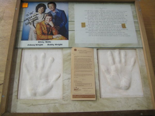 Kitty Wells Framed Hand Prints and Autograph, Ver: Kitty Wells Framed Hand Prints, Autographed Photo and Flyer All of the hand prints came from the estate of Ed Huffman who had a traveling museum called "Museum Americana" in which he traveled the coun