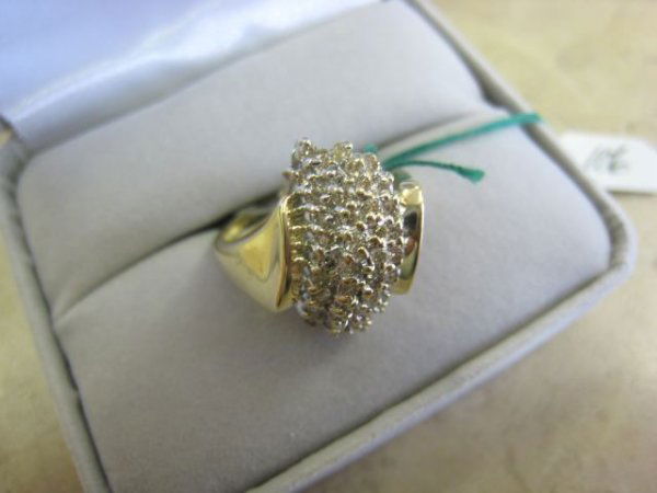 Ladies Cluster Ring: Ladies cluster ring w/ 1/2 ct total weight of full cut genuine diamonds, solid gold