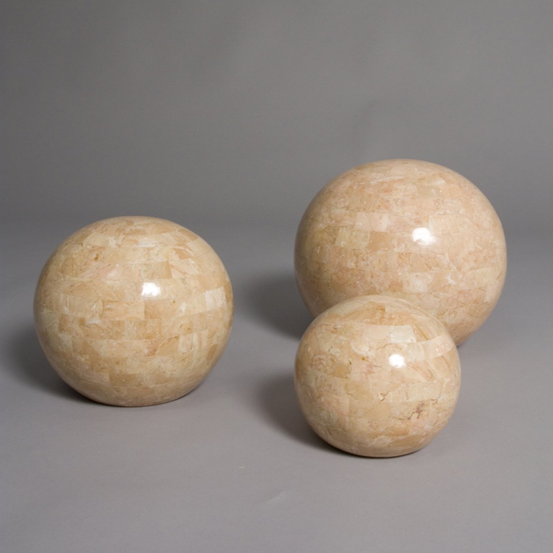 Tessellated Spheres, Set of Three: Set of three rose colored tessellated spheres, in graduated sizes. By Maitland Smith, English, 1970s. From largest to smallest the spheres measure 8 in x 9 in, 6 in x 7 in, and 4 x 5 in.