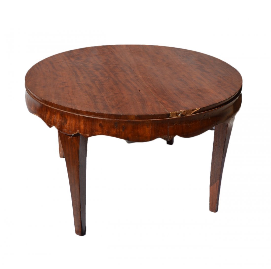 Antique Austrian Dining Table: Circular fruitwood dining table with scalloped apron and tapering legs. [46" Dia x 29 1/4" H]. Missing leaves. Chips in veneer with losses with some scuffs and scratches.