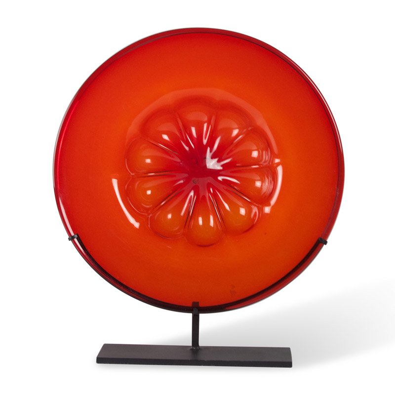 Red Tinted Glass Charger on Stand, Venini: Red tinted glass charger, the center portion having formed flower depression, mounted on custom iron stand, by Venini, Murano, Italy 1930s. Mounted height 15 in, depth 2 1/2 in., diameter 12 1/2 in.