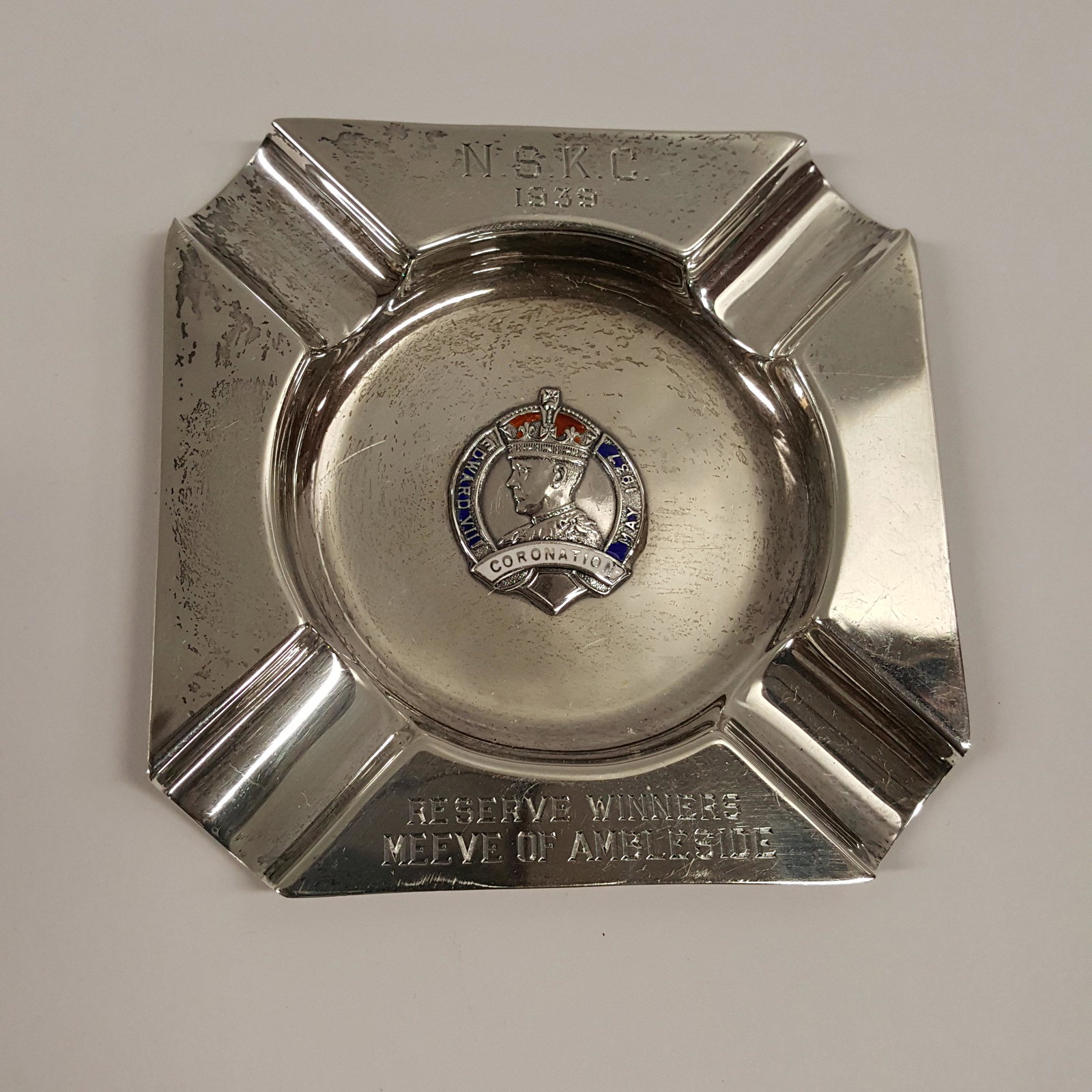 ENGLISH STERLING SILVER Ashtray: ENGLISH STERLING SILVER Ashtray form trophy with enamel center and dated 1939. Chester hallmarks, Made in England for Shreve Crump and Low, Boston. 4” square, weight, 2.1 troy oz.