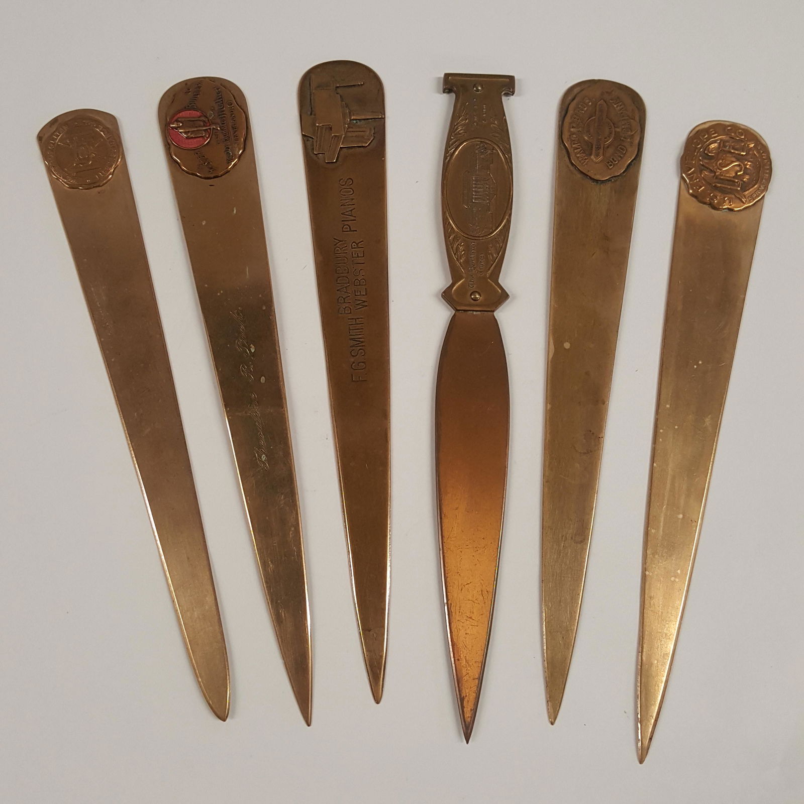 Six BRASS LETTER OPENERS, applied medallions on each, (1 of 6)