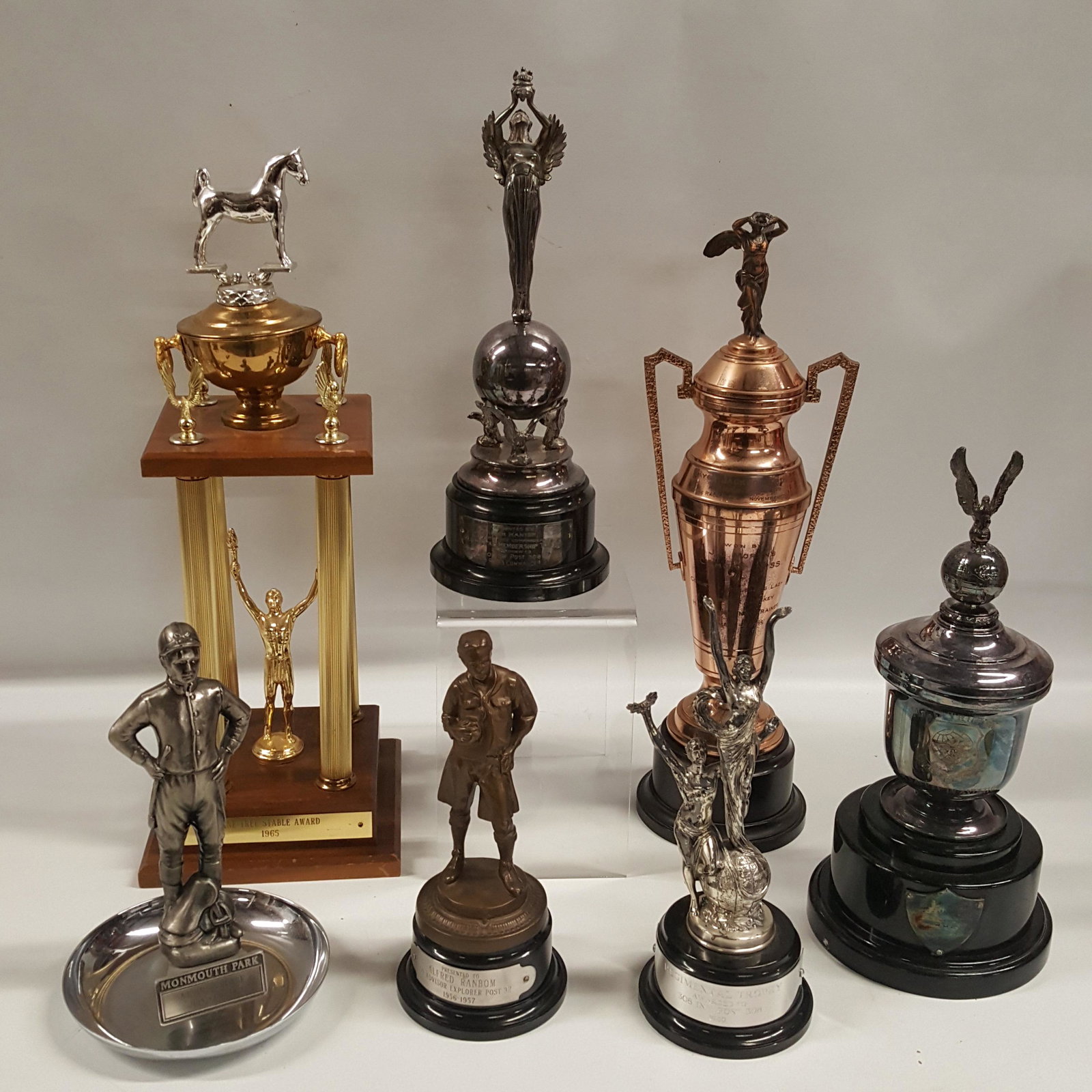 VARIOUS SPORTS RELATED TROPHIES, Equestrian: VARIOUS SPORTS RELATED TROPHIES, including horse racing, swimming, football, 11 to 22.5 inches H some of the engravings on the trophies say: Pine tree stable award 1965 Mac trophy military airlift com