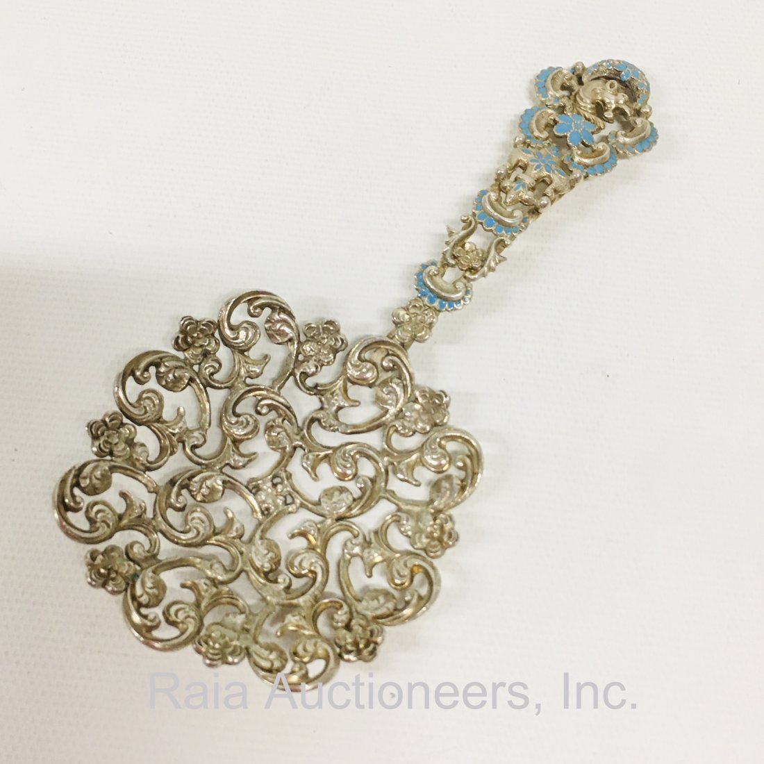 Sterling Silver and Enamel Bon Bon Spoon: Sterling silver and enamel decorated openwork Bon Bon spoon, elaborate scrolling open bowl, robins egg blue enamel handle with dragon head at the end. Marked on back F Sterling. Length, 5 inches 1.1 o