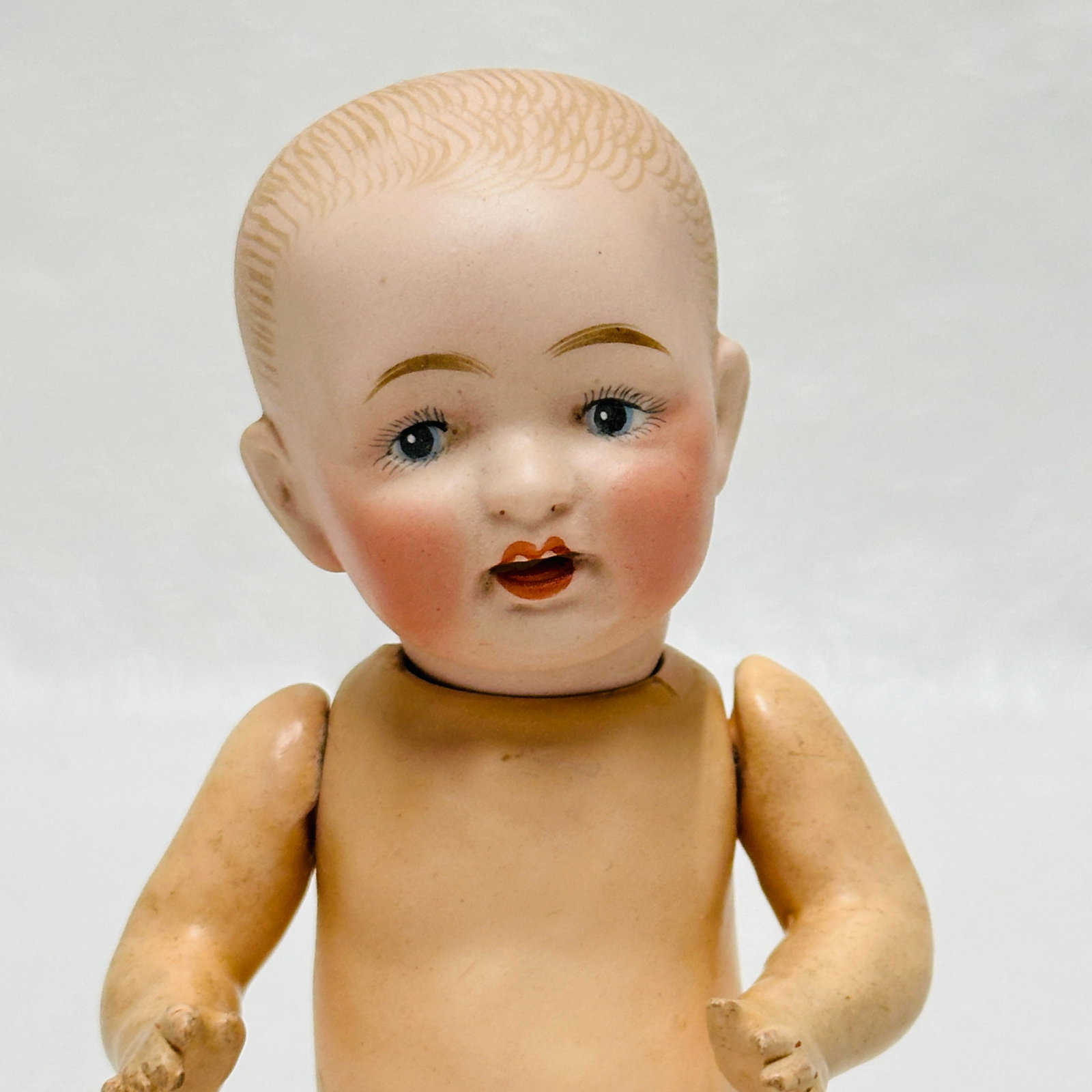 Antique Painted Bisque Character Head baby Doll: Antique Painted Bisque Character Head baby Doll, Dome head with painted hair, painted eyes and darling open laughing mouth with tongue protruding and no teeth, composition baby body with original fini