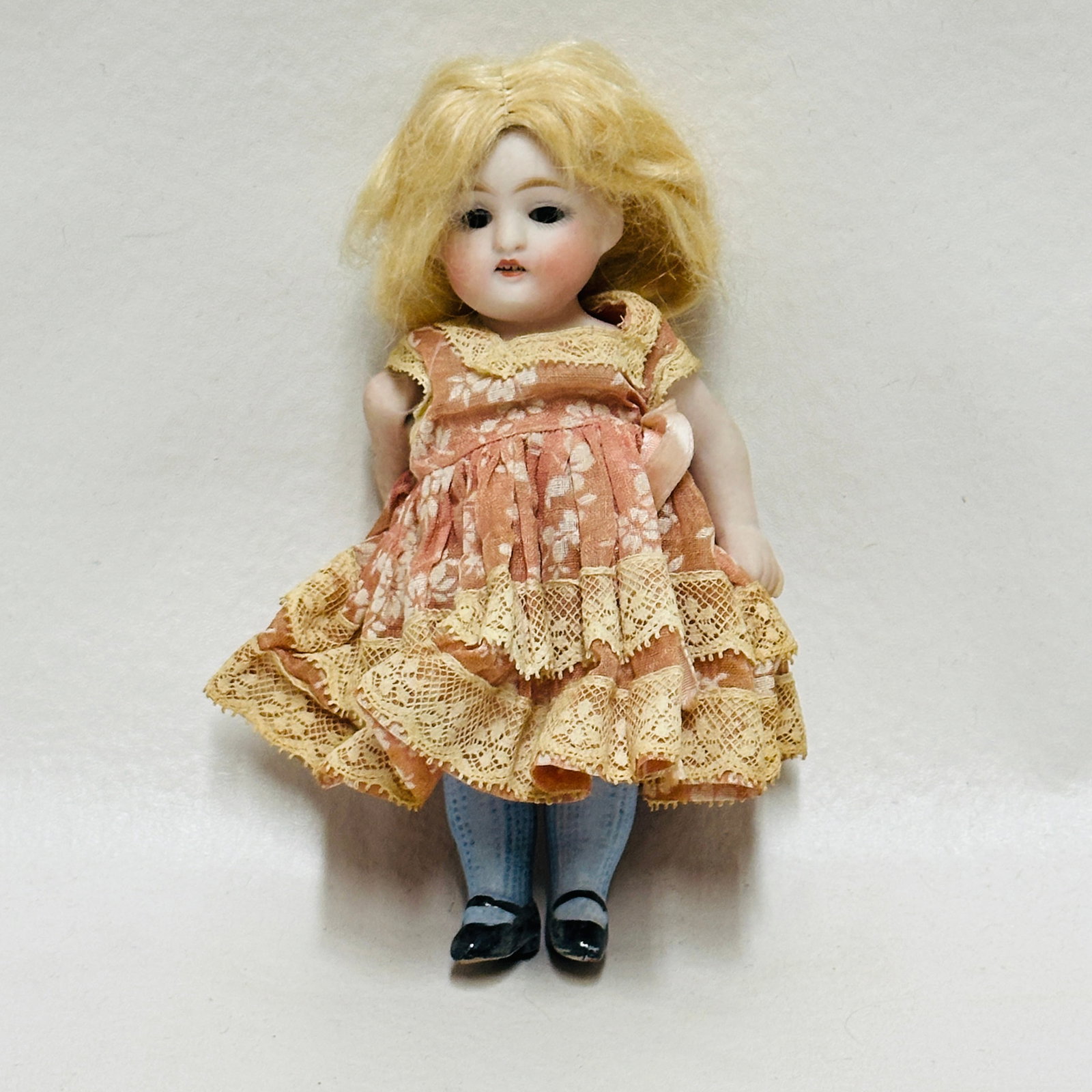 All Bisque Doll in pink floral dress: Dark blue sleep eyes, open mouth with teeth, original blonde mohair wig, painted socks and shoes with blue stripe, original dress, All Bisque Doll in pink floral dress ------------------ please review