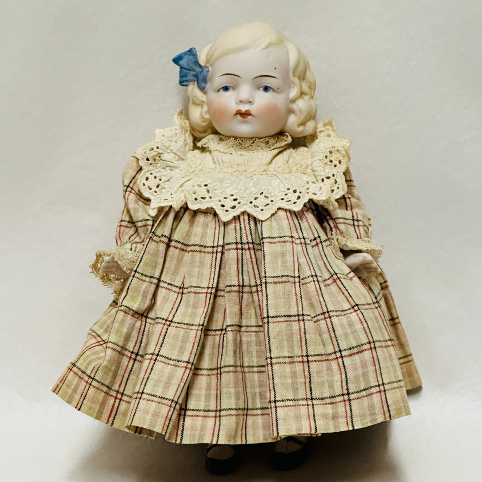 Painted All Bisque Doll with Blue Ribbon: Blue painted eyes, very pouty mouth, single stroke eyebrows, painted hair, on bisque body with painted shoes and socks with stripe - left leg has flaw in making, mommy made costume, Painted All Bisque