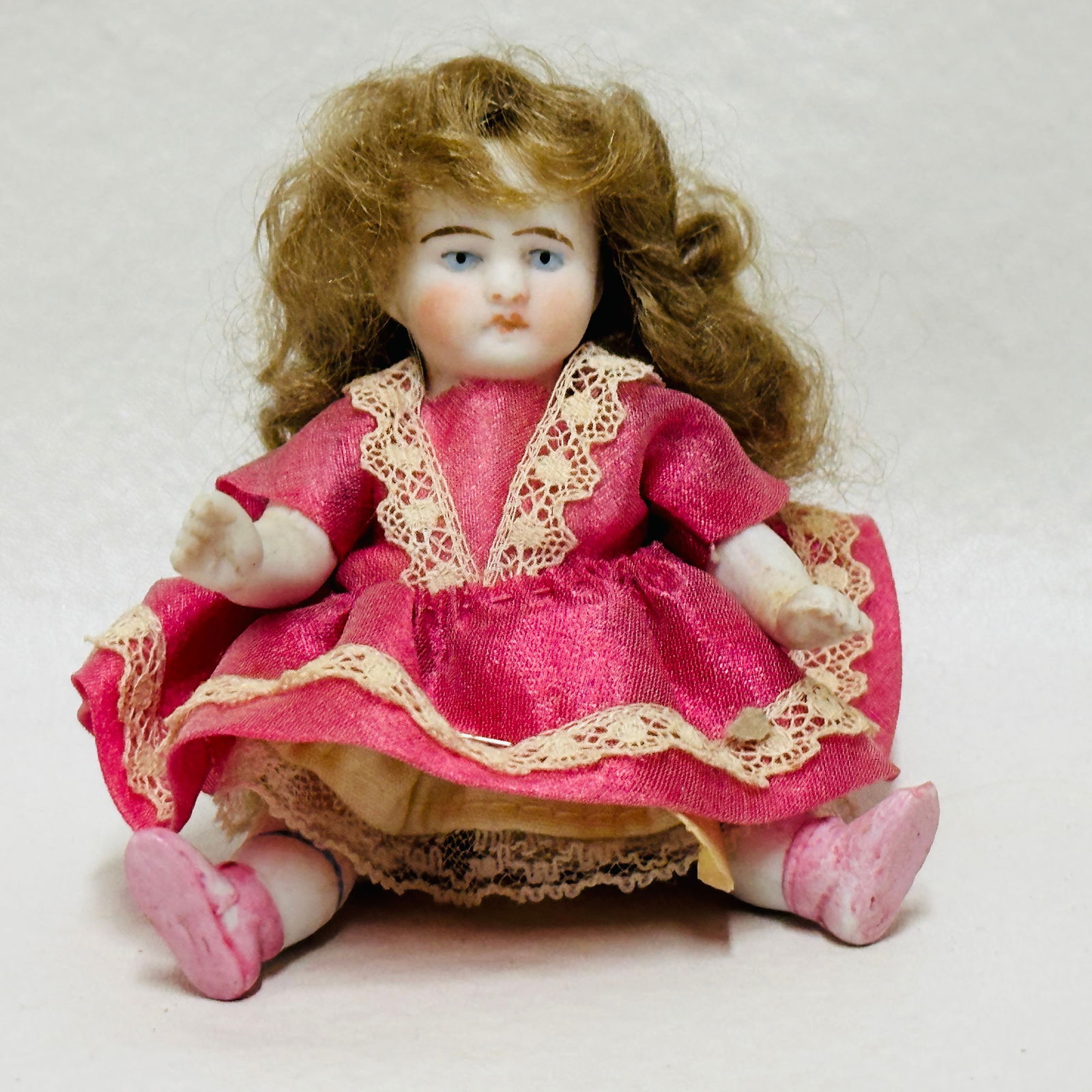 Antique All Bisque Doll: Blue painted eyes, pouty mouth, heavy brows, pensive expression, original mohair wig, painted boots and socks with stripes, original costume, Antique All Bisque Doll ------------------ please review a