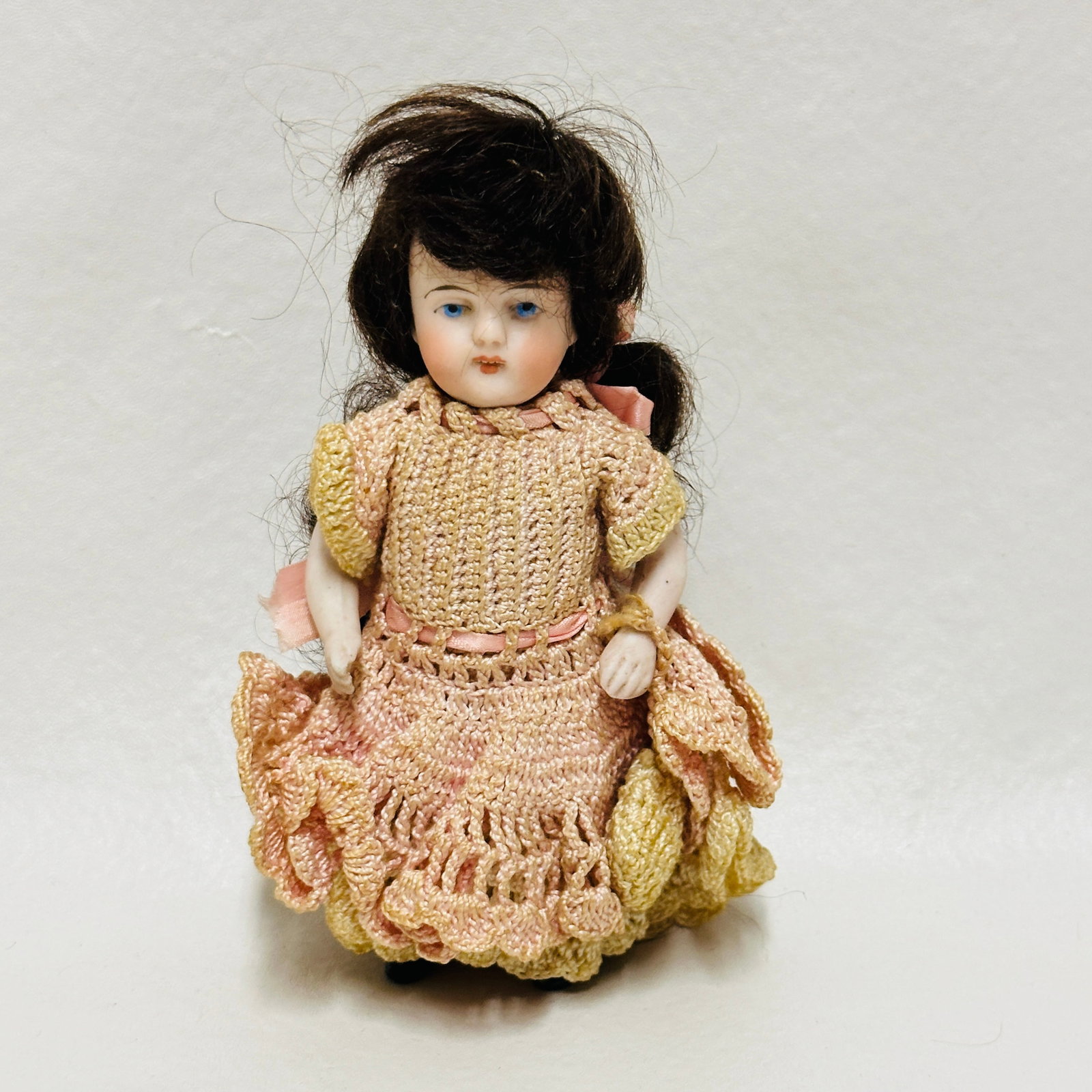 All Bisque Doll marked 12 in crochet dress: incised mark 12, Painted blue eyes, open mouth with teeth, painted socks and shoes, original mohair wig, antique crocheted dress some fading, All Bisque Doll in crochet dress ------------------ please