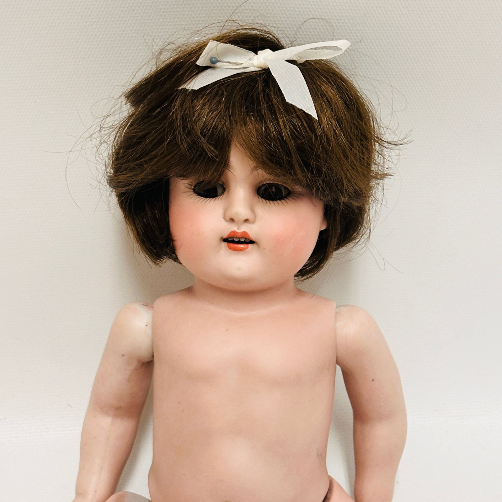 Kestner mold 150 All Bisque Doll: Kestner mold 150 all bisque with replaced dark brown wig and pate, dark brown sleep eyes, open mouth with four teeth, painted textured socks and shoes, fingers broken on one hand, foot broken and repa