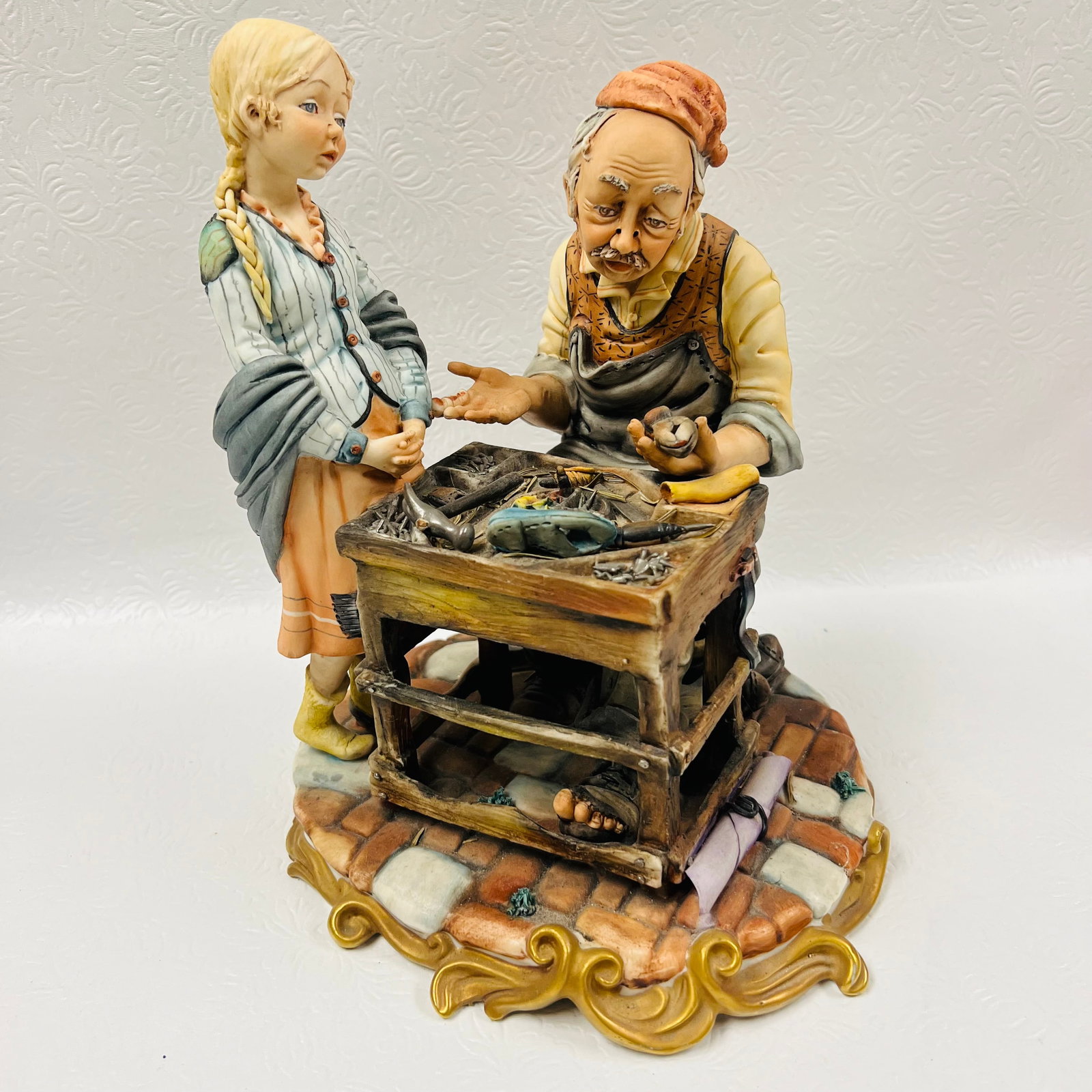 Capodimonte Shoemaker and Girl: Capodimonte Shoemaker and Girl ------------------ please review all pictures carefully because they are part of the description and show condition issues if any ------------------ please consider the 