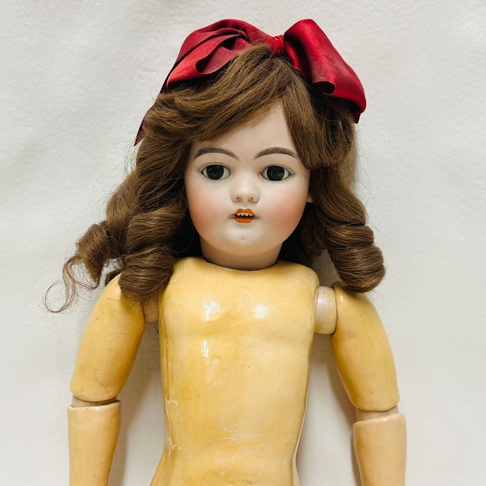 Antique German Bisque Head DEP 11 Doll: Simon and Halbig DEP with dark brown sleep eyes, nice bisque, open mouth with teeth, chin dimple, replaced wig, on wood and compo body with original finish. Antique German Bisque Head DEP 11 Doll **PL