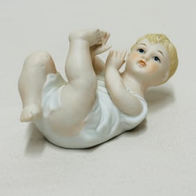 Painted Bisque Porcelain Piano Baby