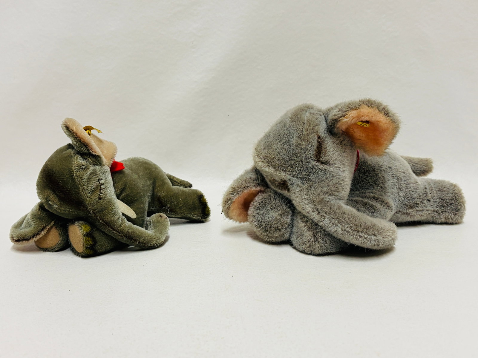 Two Steiff Lying Elephants Floppy Jumbo and Floppy Ele: Two Steiff Lying Elephants Floppy Jumbo and Floppy Ele ------------------ please review all pictures carefully because they are part of the description and show condition issues if any
