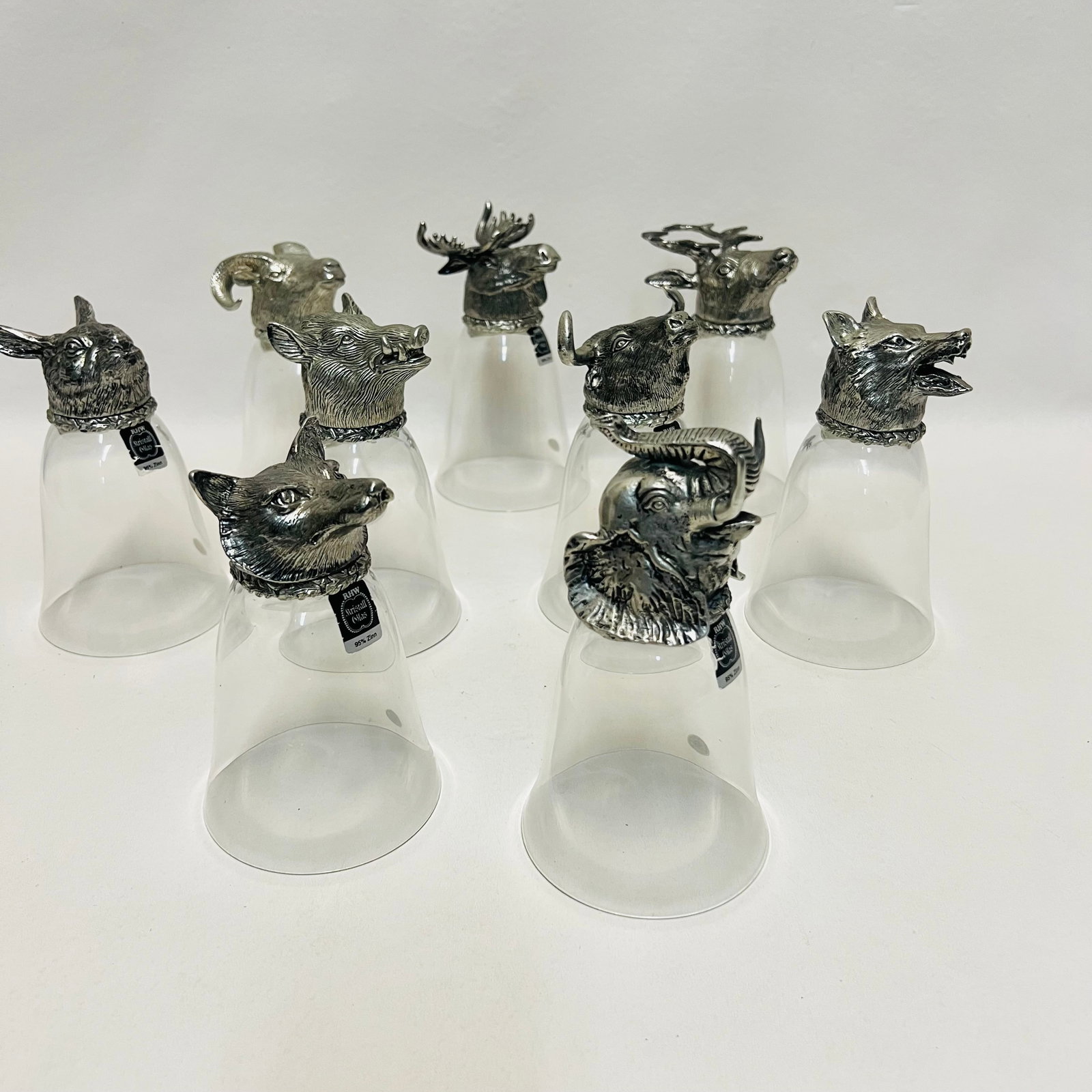 German Sturzbecher Set, 9 Wildlife Animal Head Upside-Down Shot Glasses: Collection consists of vintage German Sturzbecher (literally "tumble-cups" or stirrup cups), traditionally designed as shot or cordial glasses that cannot be set down until they are emptied, resting u